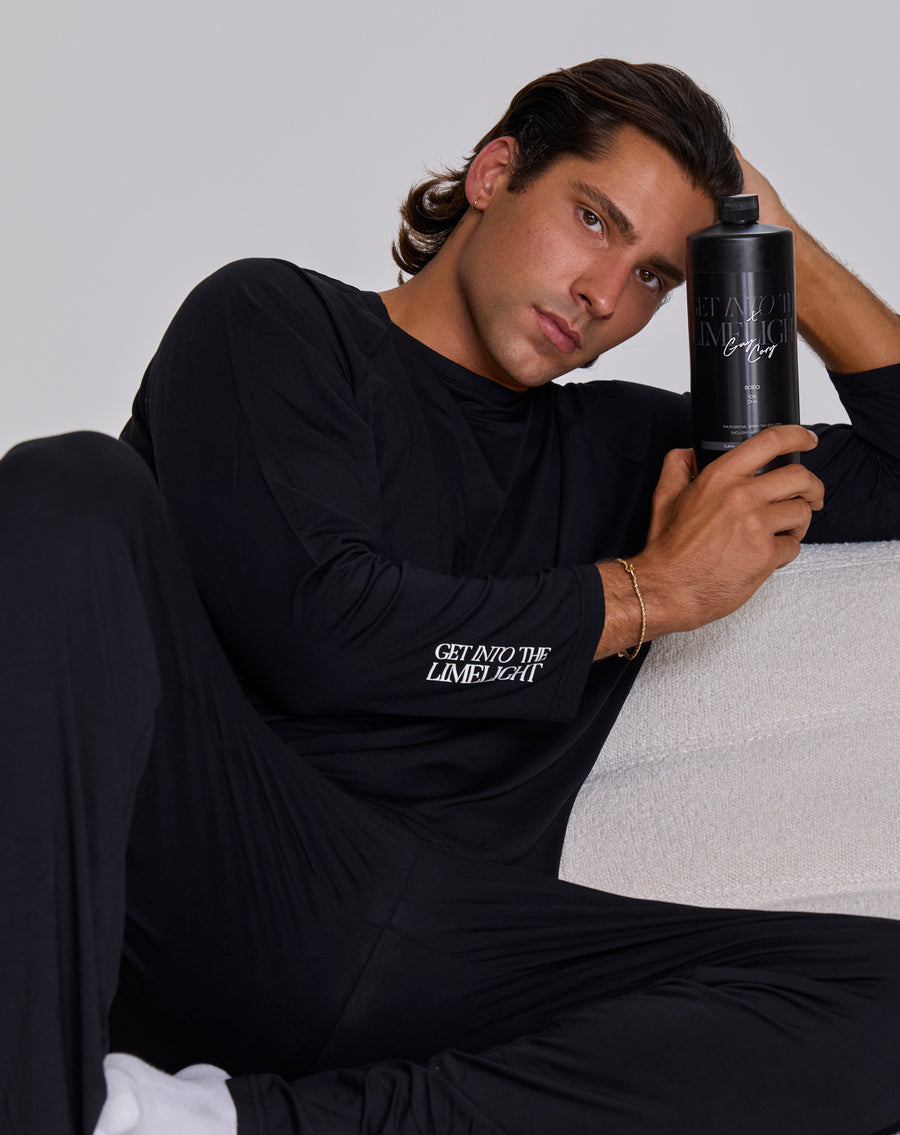 Celebrity Spray Tan artist Guy Cory @guycorytans wearing Get Into The Limelight Tanning Pajamas and holding GITL x Guy Cory Professional Spray Tan Solution